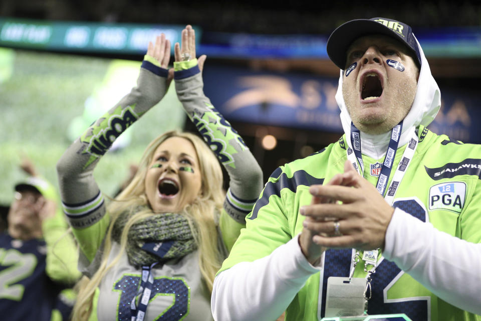 Seattle Seahawks fans celebrate a win during an NFL game against the Los Angeles Rams, Thursday, Oct. 3, 2019, in Seattle. The Seahawks defeated the Rams 30-29. (Margaret Bowles via AP)