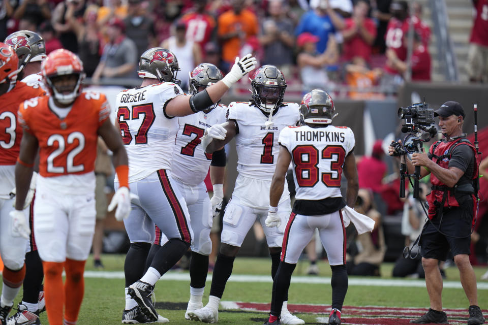 Tampa Bay Buccaneers running back Rachaad White (1) celebrates scoring a touchdown with teammates during the first half of an NFL football game against the Chicago Bears, Sunday, Sept. 17, 2023, in Tampa, Fla. (AP Photo/Chris O'Meara)