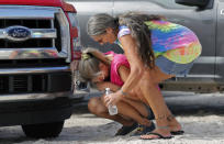 FILE - In this Oct. 17, 2018 file photo Nancy Register weeps as she is comforted by Roxie Cline, right, after she lost her home and all the contents inside to Hurricane Michael in Mexico Beach, Fla. The tropical weather that turned into monster Hurricane Michael began as a relatively humble storm before rapidly blossoming into the most powerful cyclone ever to hit the Florida Panhandle, causing wrenching scenes of widespread destruction.(AP Photo/Gerald Herbert, File)