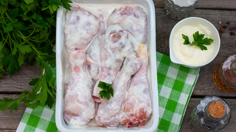 chicken marinating in yogurt in dish