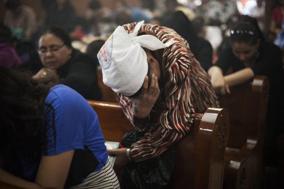 An Egyptian Coptic Christian woman prays in a church within Al-Mahraq Monastery in Assiut, Upper Egypt, Tuesday, Aug. 6, 2013. Islamists may be on the defensive in Cairo, but in Egypt's deep south they still have much sway and audacity: over the past week, they have stepped up a hate campaign against the area's Christians. Blaming the broader Coptic community for the July 3 coup that removed Islamist president Mohammed Morsi, Islamists have marked Christian homes, stores and churches with crosses and threatening graffiti. (AP Photo/Manu Brabo)