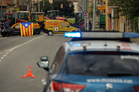 Trucks and cars block a street during a partial regional strike called by pro-independence parties and unions in Bascara, Spain, October 3, 2017. REUTERS/Vincent West