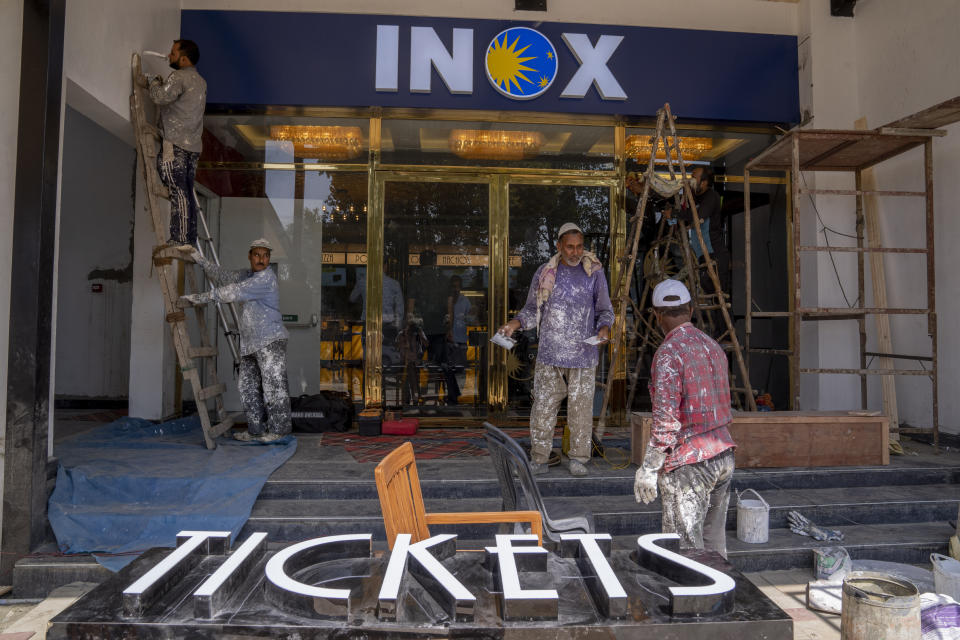 Laborers work outside the newly constructed 'INOX' multiplex in Srinagar, Indian controlled Kashmir, Monday, Sept. 19, 2022. The multi-screen cinema hall has opened in the main city of Indian-controlled Kashmir for public for the first time in 14 years. The 520-seat hall with three screens opened on Saturday, Oct. 1, amid elaborate security but only about a dozen viewers lined up for the first morning show. (AP Photo/Dar Yasin)
