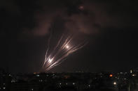 Rockets seen in the sky fired by Palestinian militants toward Israel, over Gaza City, Saturday, Aug. 6, 2022. The latest confrontation between Israel and Gaza militants is in its second day, as Israeli jets hit targets in Gaza and rocket fire persists into southern Israel. Palestinian officials say at least 15 people have been killed in Gaza, including a senior militant leader and a 5-year-old girl. (AP Photo/Adel Hana)