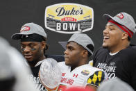 Maryland defensive back Jakorian Bennett, center, holds the trophy after Maryland defeated North Carolina State in the Duke's Mayo Bowl NCAA college football game in Charlotte, N.C., Friday, Dec. 30, 2022. (AP Photo/Nell Redmond)