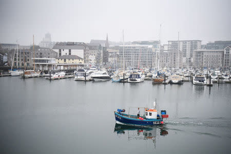 FILE PHOTO: A fishing boat sails from the harbour as as Britain's Prime Minister Theresa May visits Plymouth fisheries, in Plymouth, May 31, 2017. REUTERS/Leon Neal/Pool/File Photo