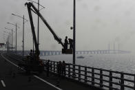 <p>People work on the Hong Kong-Zhuhai-Macau Bridge, in Zhuhai city, south China’s Guangdong province in March. (AP Photo/Kin Cheung) </p>