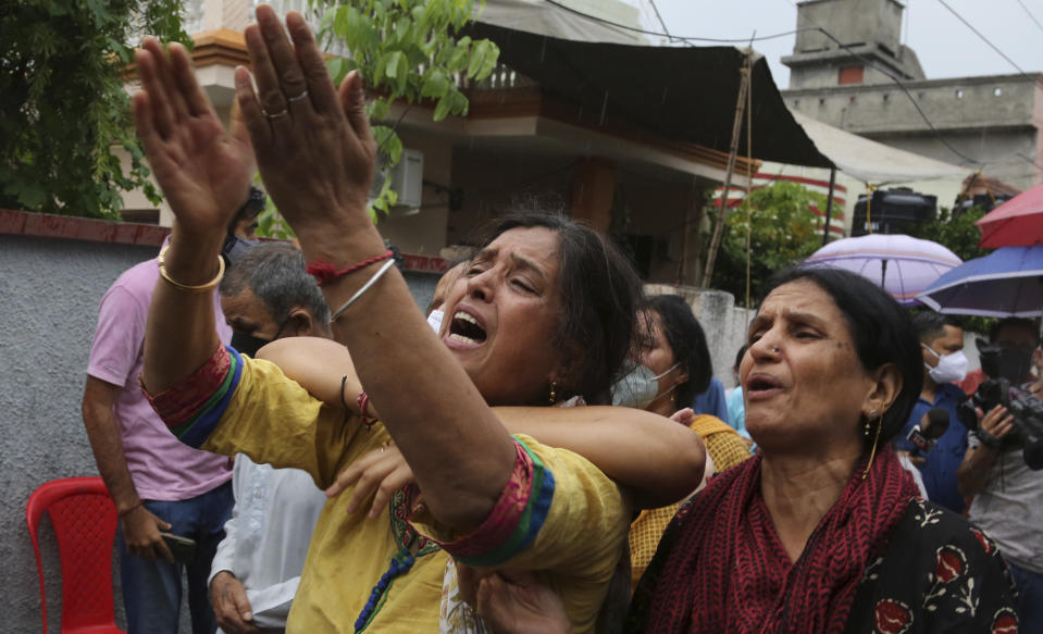 Relatives of Rakesh Pandita, a politician who was killed late Wednesday, mourns at their residence in Jammu, India, Thursday, June.3, 2021. Assailants fatally shot the politician belonging to India’s ruling party in disputed Kashmir, police said Thursday, blaming separatist rebels for the attack. The unidentified assailants fired at Pandita late Wednesday in the southern town of Tral, where he was visiting a friend, police said. He was declared dead in a hospital. (AP Photo/Channi Anand)