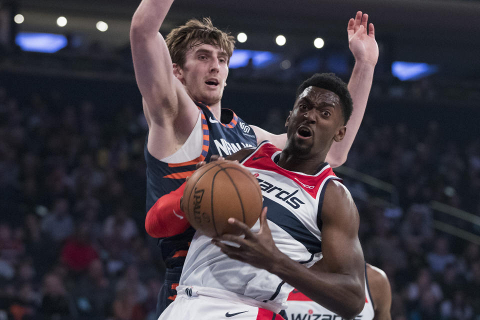 New York Knicks forward Luke Kornet, background, guards Washington Wizards forward Bobby Portis during the first half of an NBA basketball game, Sunday, April 7, 2019, at Madison Square Garden in New York. (AP Photo/Mary Altaffer)