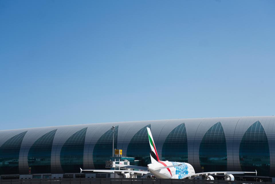 In this Friday, May 8, 2020 photo, an Emirates Airbus A380 sits at a gate at Dubai International Airport amid the coronavirus pandemic that's halted global aviation in Dubai, United Arab Emirates. Dubai built a city on the promise of globalization, creating itself as a vital hub for the free movement of trade, people and money worldwide. Now, with events cancelled, flights grounded and investment halted, this sheikhdom in the UAE faces both the threat of the virus and a growing economic crisis. (AP Photo/Jon Gambrell)