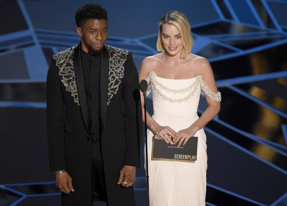 Chadwick Boseman, left, and Margot Robbie present the award for best adapted screenplay at the Oscars on Sunday, March 4, 2018, at the Dolby Theatre in Los Angeles. (Photo by Chris Pizzello/Invision/AP)