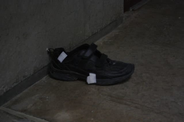 A shoe from a detainee left on the now-empty cell block.