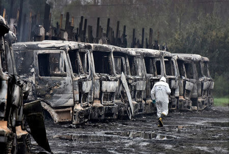 Burnt-out trucks are pictured in the San Jose de La Mariquina commune, south of Santiago, Chile August 28, 2017. REUTERS/Miguel Angel Bustos ATTENTION EDITORS - NO RESALES. NO ARCHIVES. CHILE OUT. NO COMMERCIAL OR EDITORIAL SALES IN CHILE