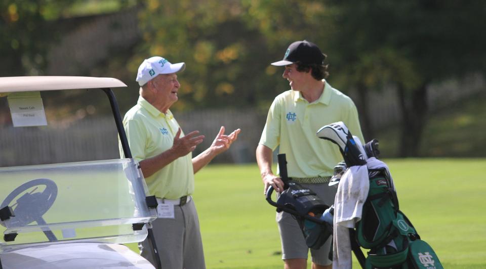 Newark Catholic coach Phil West and Brogan Sullivan talk between shots at the Division III district tournament Oct. 4 at  Turnberry.