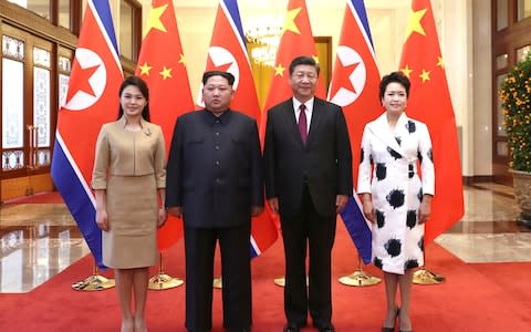 Chinese President Xi Jinping, second from right, and his wife Peng Liyuan, right, and North Korean leader Kim Jong Un, second from left, and his wife Ri Sol Ju - Credit: AP