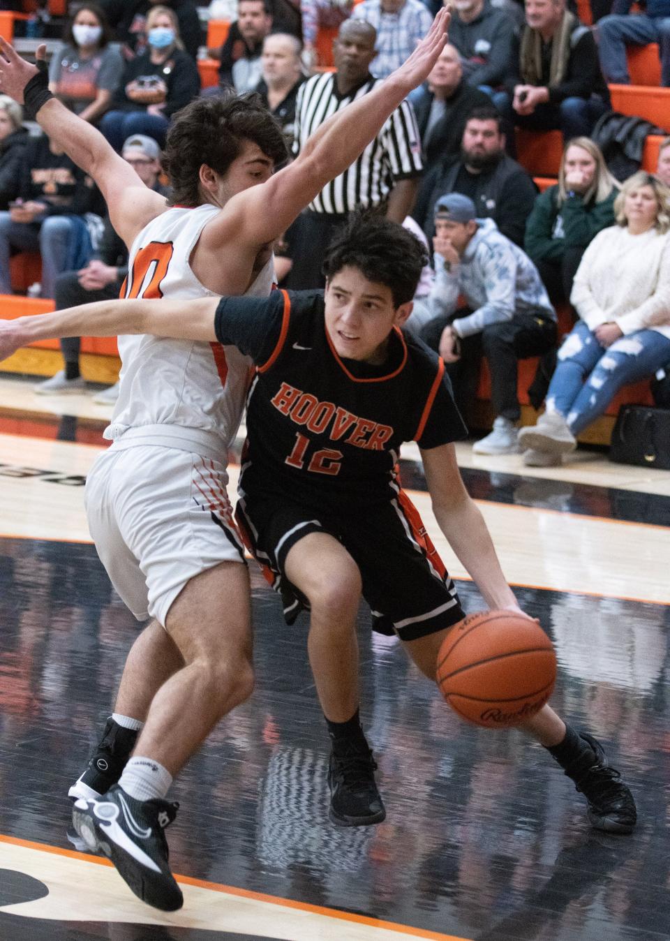 Hoover’s Mathew Mizner drives around Green’s Marc Adam on Friday, Jan. 21, 2022.