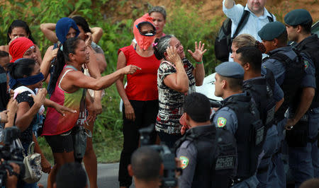 Relatives of prisoners react near riot police at a checkpoint close to the prison where around 60 people were killed in a prison riot in the Amazon jungle city of Manaus, Brazil, January 2, 2017. REUTERS/Michael Dantas