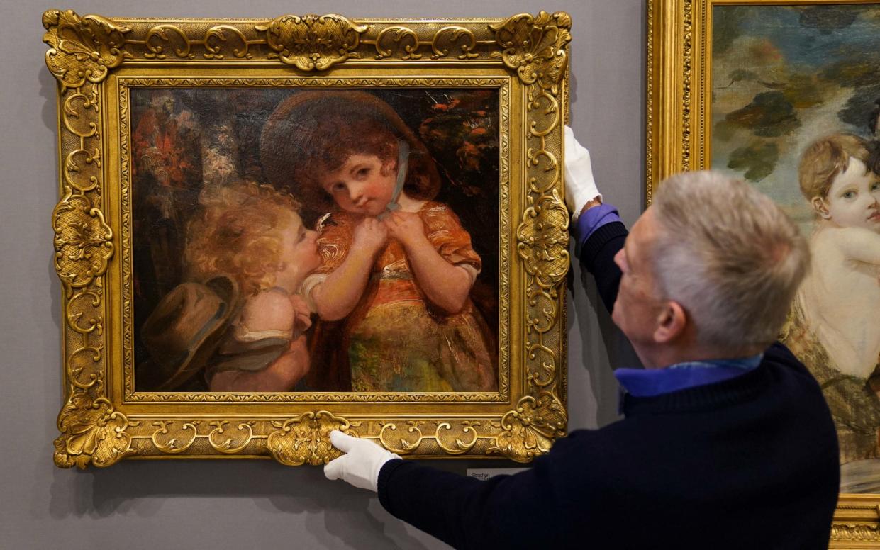 Russell Strachan adjusts the Sir Joshua Reynolds painting found 'beaten up' at an obscure auction - Jacob King/PA Wire