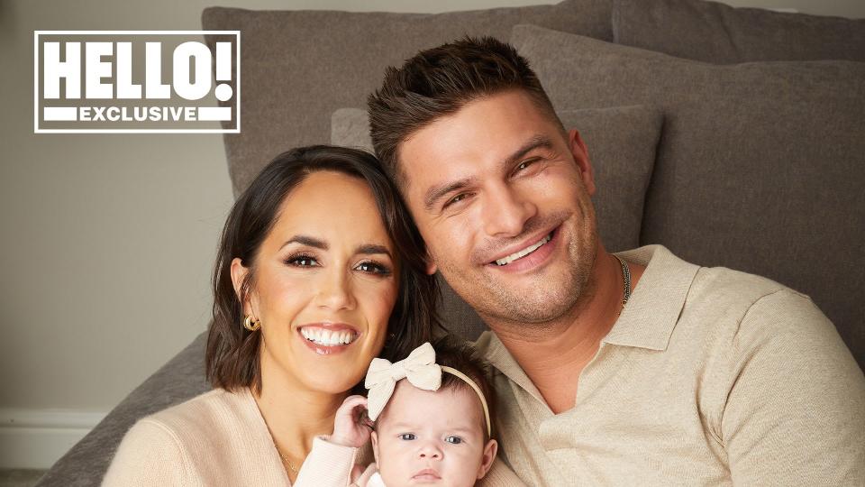 Janette Manrara and Aljaz Skorjanec pose in biscuit coloured tops with baby Lyra