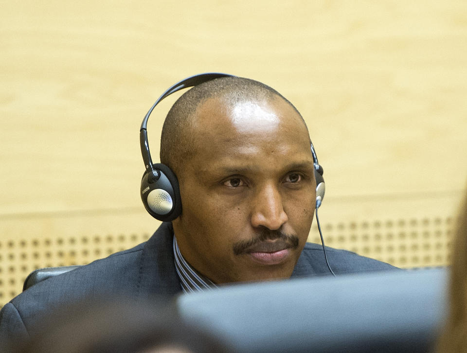 Bosco Ntaganda awaits the start of a hearing at the International Criminal Court (ICC) in The Hague, Netherlands, Monday Feb. 10, 2014. Judges at the ICC are weighing whether there is enough evidence to proceed to trial in the case against Bosco Ntaganda, the former leader of a rebel group in Congo’s unstable eastern region. Prosecutor Fatou Bensouda accused Ntaganda of 13 charges of war crimes and 5 charges of crimes against humanity for acts including murder, rape, persecution and recruiting child soldiers. Ntaganda's lawyers have said he is innocent of any wrongdoing. (AP Photo/Toussaint Kluiters, Pool)