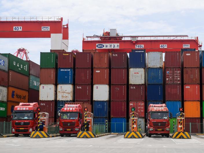 Containers wait to be stacked onto trucks at at Yangshan Deepwater Port in Shanghai, China, on April 27.
