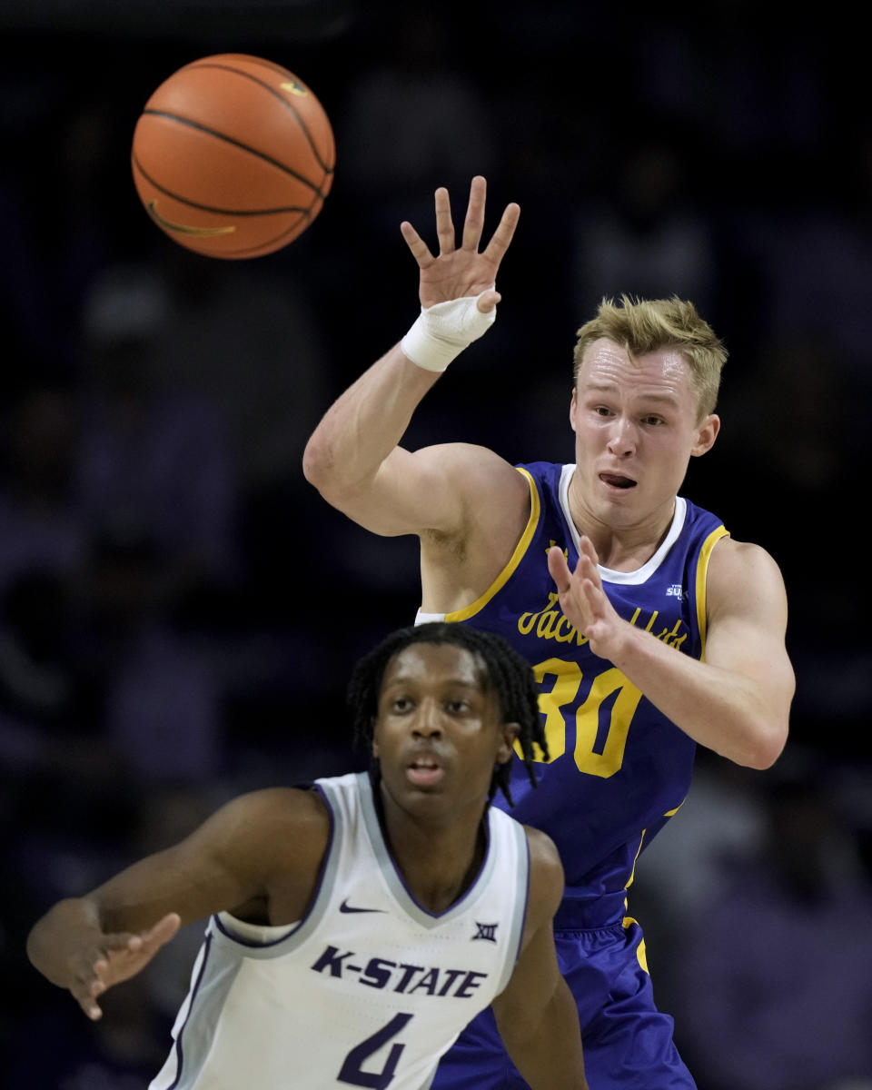 South Dakota State guard Charlie Easley (30) passes over Kansas State guard Darrin Ames (4) during the first half of an NCAA college basketball game Monday, Nov. 13, 2023, in Manhattan, Kan. (AP Photo/Charlie Riedel)