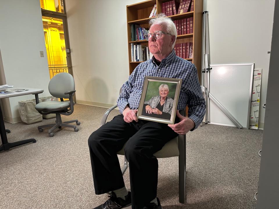 Michael Kruzich holds a photo of his late mother Donna during an interview Monday, April 15, 2024, in Lansing, Mich. Donna Kruzich was one of dozens of people in the U.S. who died after being injected with tainted steroids made by a specialty pharmacy in Massachusetts. Now, more than a decade later, the operator of the New England Compounding Center is returning to a Michigan court to be sentenced on involuntary manslaughter charges. (AP Photo/Mike Householder)