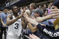 Butler's Kamar Baldwin (3) celebrates with fans after Butler defeat Marquette in overtime of an NCAA college basketball game against Marquette, Friday, Jan. 24, 2020, in Indianapolis. Butler won 89-85. (AP Photo/Darron Cummings)