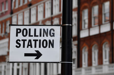 A polling station direction sign is seen placed on a lamppost, ahead of the forthcoming EU elections, in London, Britain, May 21, 2019. REUTERS/Toby Melville