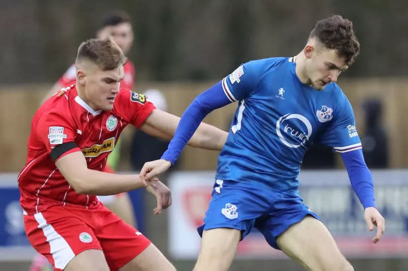 Photo shows Benji Magee taking on Cliftonville's Odhran Casey