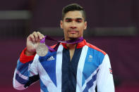 Louis Smith of Great Britain celebrates with his silver medal during the medal ceremony following the Artistic Gymnastics Men's Pommel Horse final on Day 9 of the London 2012 Olympic Games at North Greenwich Arena on August 5, 2012 in London, England. (Photo by Quinn Rooney/Getty Images)