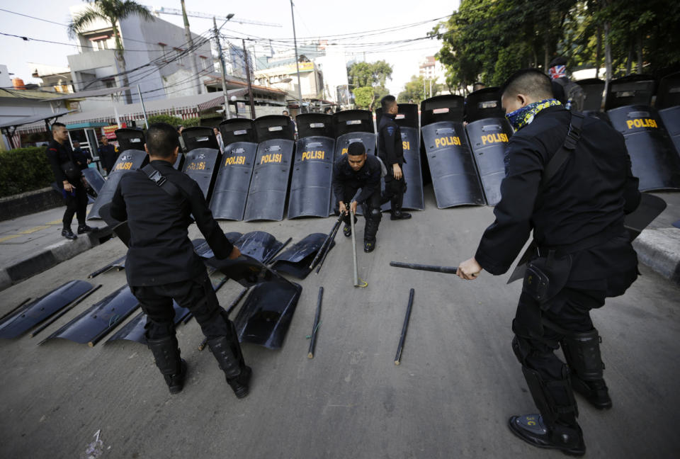 Police officers arrange their riot gears a day after the clash with supporters of Indonesian presidential candidate Prabowo Subianto in Jakarta, Indonesia, Thursday, May 23, 2019. The defeated candidate in Indonesia's presidential election is expected to challenge the result in court Thursday as calm returned to the capital following a 24-hour spasm of apparently orchestrated violence. (AP Photo/Dita Alangkara)