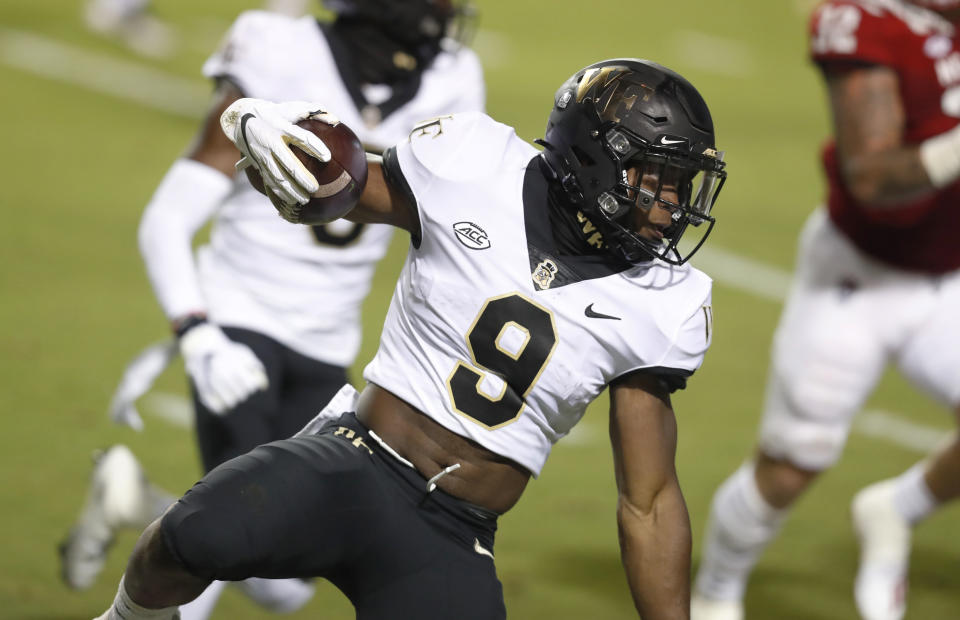 Wake Forest running back Kenneth Walker III (9) looks for room to run against North Carolina State during the first half of an NCAA college football game in Raleigh, N.C, Saturday, Sept. 19, 2020. (Ethan Hyman/The News & Observer via AP)
