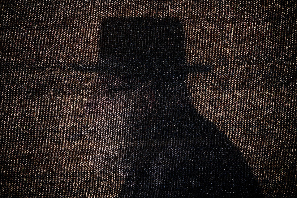 <p>An Ultra-Orthodox Jewish man is seen through a net during Siyum Ha’Shas, a celebration marking the completion of the learning cycle of the Babylonian Talmud — a collection of oral Jewish laws and traditions passed down from generation to generation — in Jerusalem, July 31, 2012. (Photo: Oded Balilty/AP) </p>