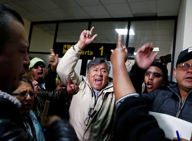 Supporters of Bolivia's President Evo Morales protest against Luis Fernando Camacho, President of Civic Committee of Santa Cruz, at the El Alto airport, on the outskirts of La Paz