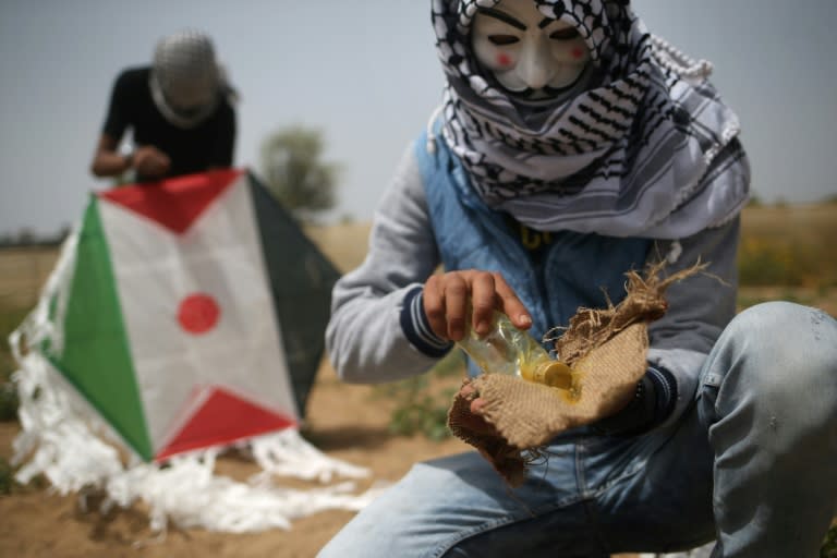 Palestinian protestors in Gaza prepare an incendiary kite before trying to fly it over the border fence with Israel on April 20, 2018