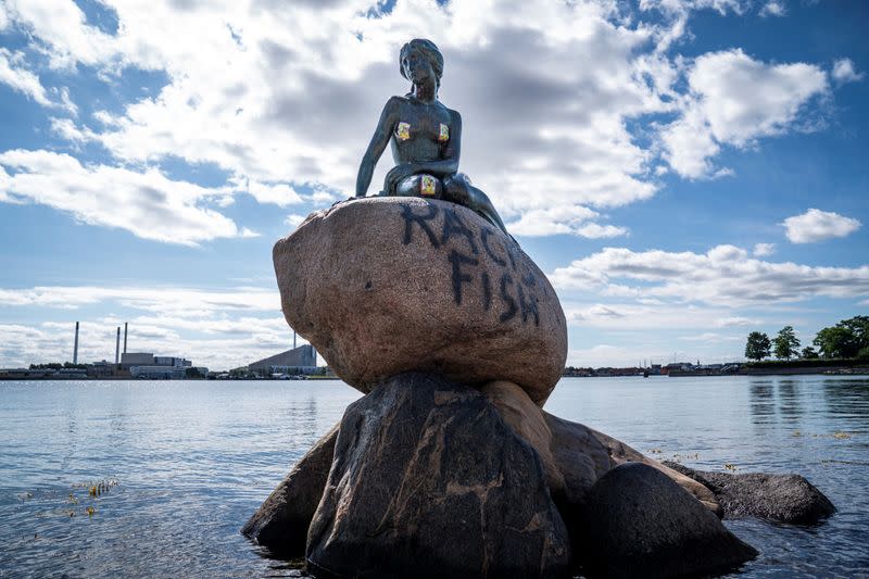 A graffiti reading "Racist Fish" is seen on a statue of "The Little Mermaid" in Copenhagen