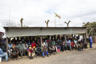 Prisoners wait for transport following their release from Chikurubi prison on the outskirts of Harare, Saturday, April 17, 2021. Zimbabwe began the release of about 3,000 prisoners under a presidential amnesty aimed at easing congestion and minimizing the threat of COVID-19 across the country's overcrowded jails. (AP Photo/Tsvangirayi Mukwazhi)