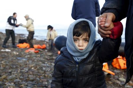 A Syrian refugee child looks on, moments after arriving on a raft with other Syrian refugees on a beach on the Greek island of Lesbos, January 4, 2016. REUTERS/Giorgos Moutafis