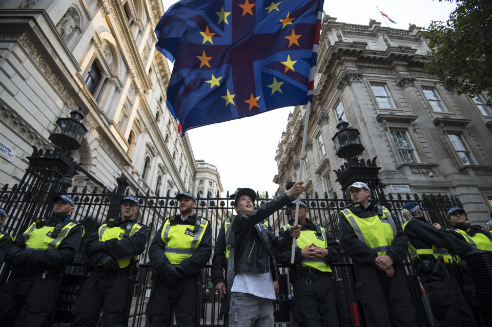 Kayden, 11, waves an EU flag and Union Jack in front of a line of police officers outside Downing Street, London, to demonstrate against Prime Minister Boris Johnson temporarily closing down the Commons from the second week of September until October 14 when there will be a Queen's Speech to open a new session of Parliament.