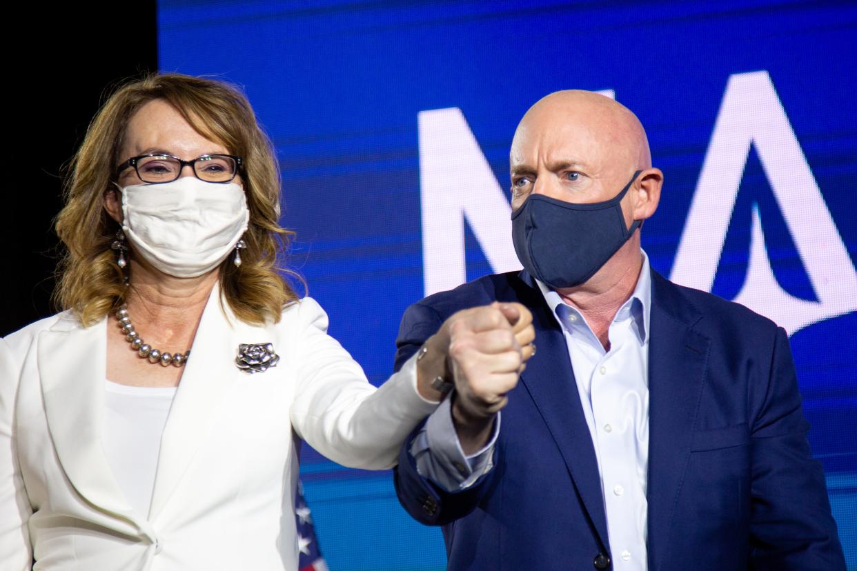 <p>Democratic US Senate candidate Mark Kelly and former Arizona congresswoman Gabrielle Giffords hold hands during the Election Night event</p> (Getty Images)