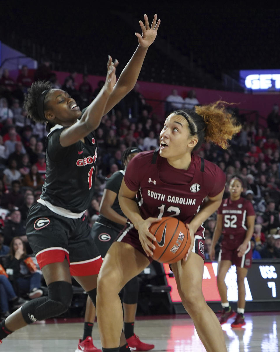 South Carolina guard Brea Beal (12) prepares to shoot past Georgia's guard Chloe Chapman (1) against during the first half of an NCAA college basketball game Sunday, Jan. 26, 2020, in Athens, Ga. (AP Photo/Tami Chappell)