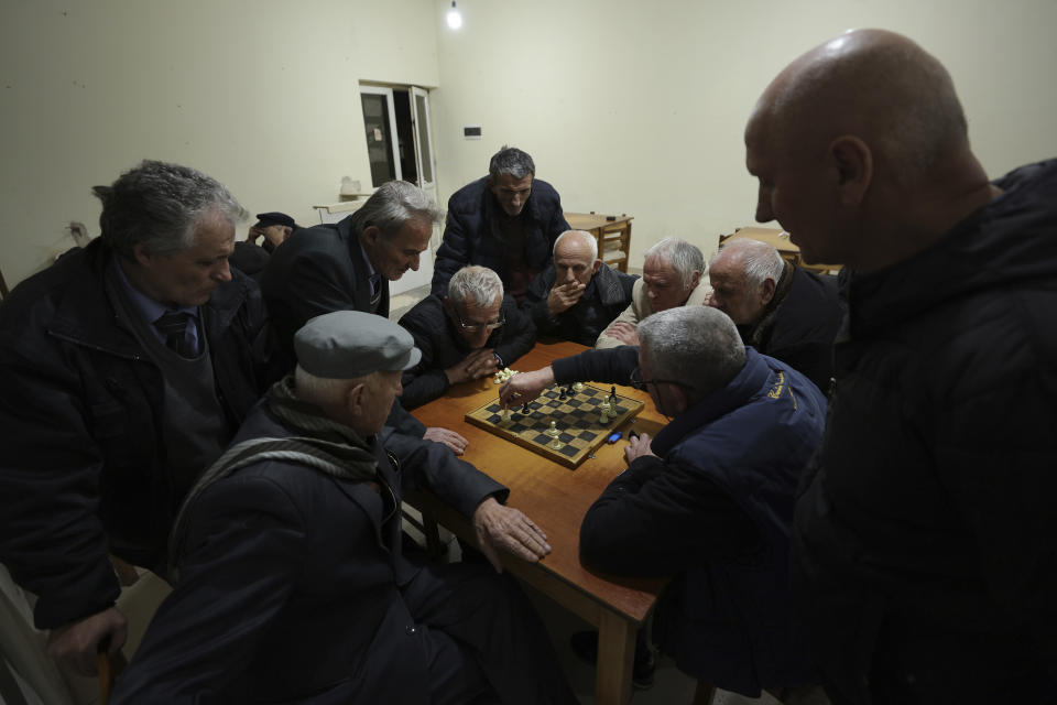 A group of elderly people play at the chess club in the city center of Kukes, 150 kilometers (90 miles) northern of Tirana, Albania, Tuesday, March 14, 2023. Thousands of young Albanians have crossed the English Channel in recent years to seek a new life in the U.K. Their dangerous journey in small boats or inflatable dinghies reflects Albania's anemic economy and a younger generation’s longing for fresh opportunities. (AP Photo/Franc Zhurda)