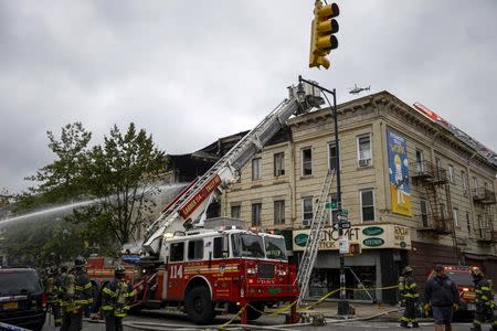 Firefighters respond to an apparent gas explosion and fire in the Brooklyn borough of New York, October 3, 2015. REUTERS/Rashid Umar Abbasi