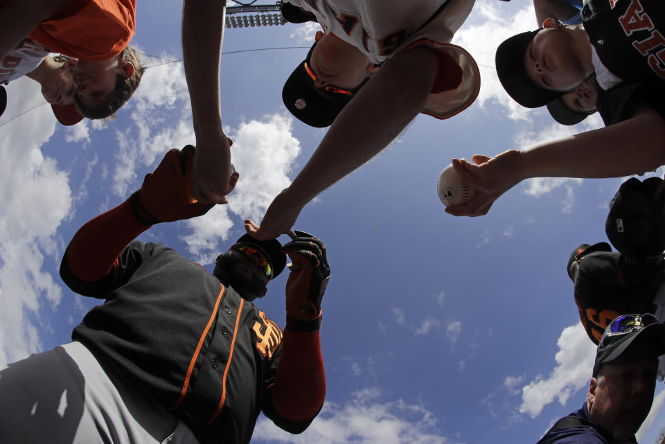 San Francisco Giants' Pablo Sandoval signs autographs for fans before a spring training baseball game against the Arizona Diamondbacks, Monday, March 2, 2020, in Scottsdale, Ariz.(AP Photo/Darron Cummings)