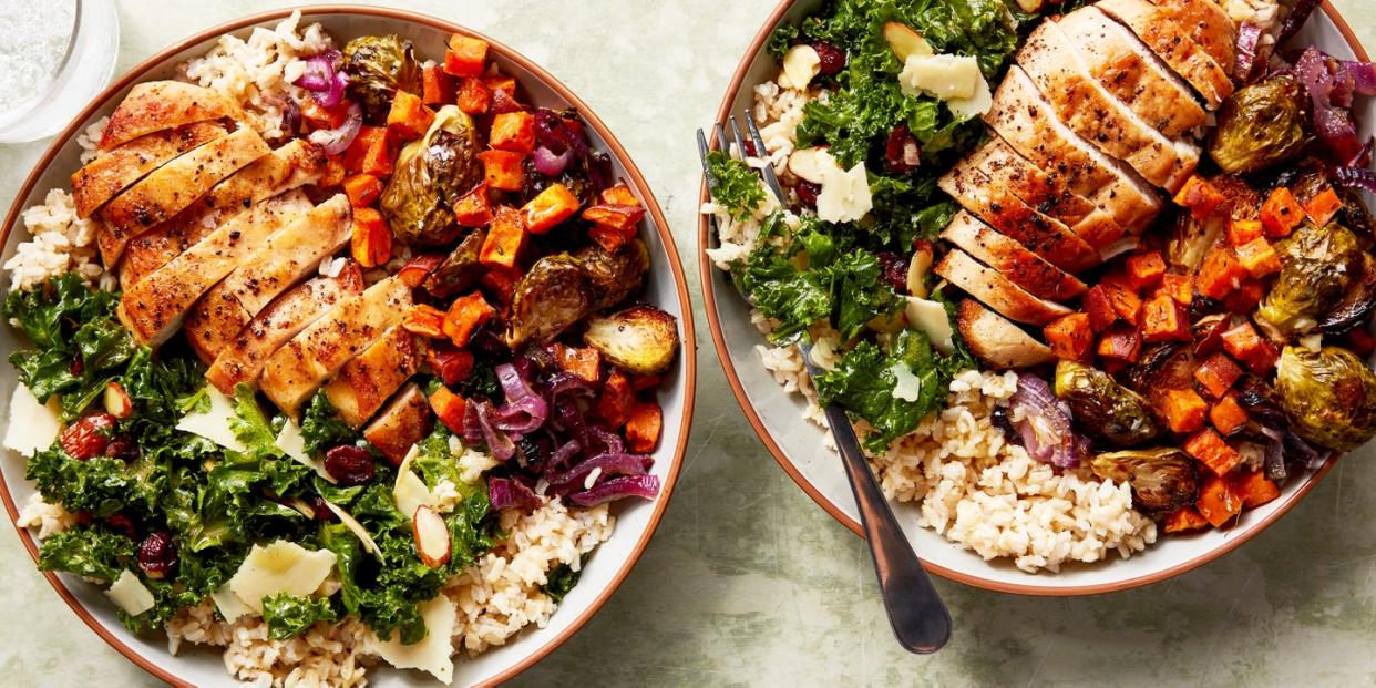 chicken, kale salad, and roasted sweet potatoes in a rice bowl