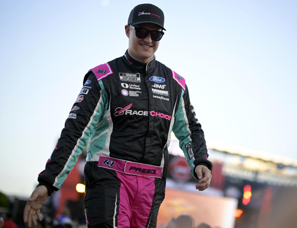 FILE - Ryan Preece slaps hands with spectators during driver introductions before a NASCAR Cup Series auto race at Daytona International Speedway, Aug. 26, 2023, in Daytona Beach, Fla. Preece might not recognize the spot where his harrowing crash started at the speedway last August. NASCAR paved over the grassy area that seemingly caused Preece’s car to become airborne and roll about a dozen times during the 400-mile summer race at the famed track. (AP Photo/Phelan M. Ebenhack, File)