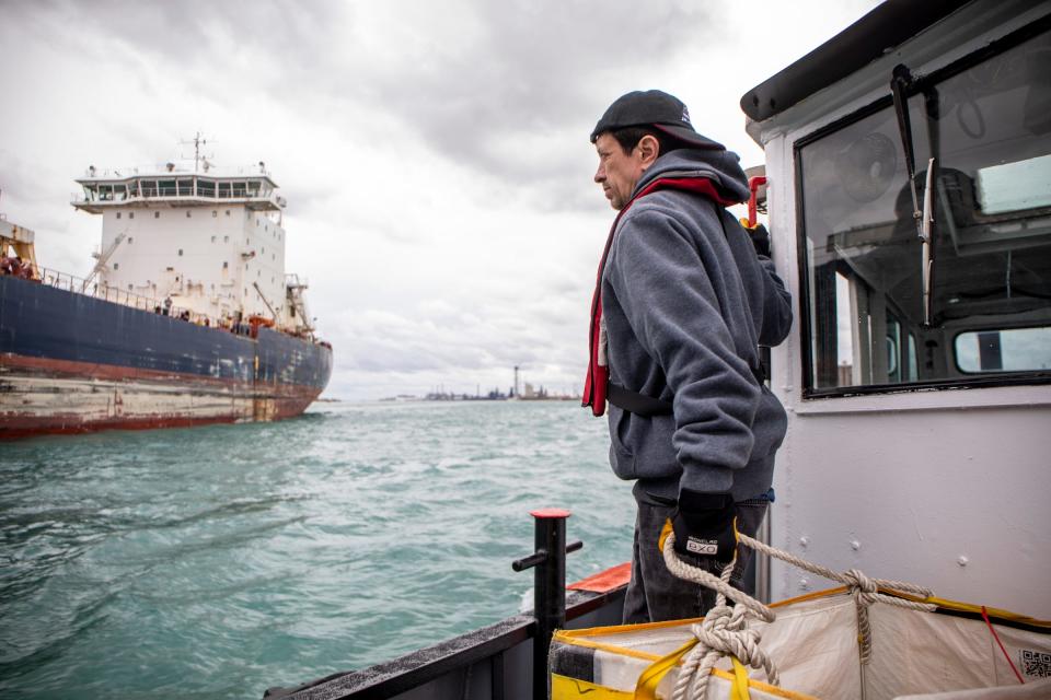Al Holland prepares to deliver packages and pizza on the J. W. Westcott II on the Detroit River on Monday, April 25, 2022. 
