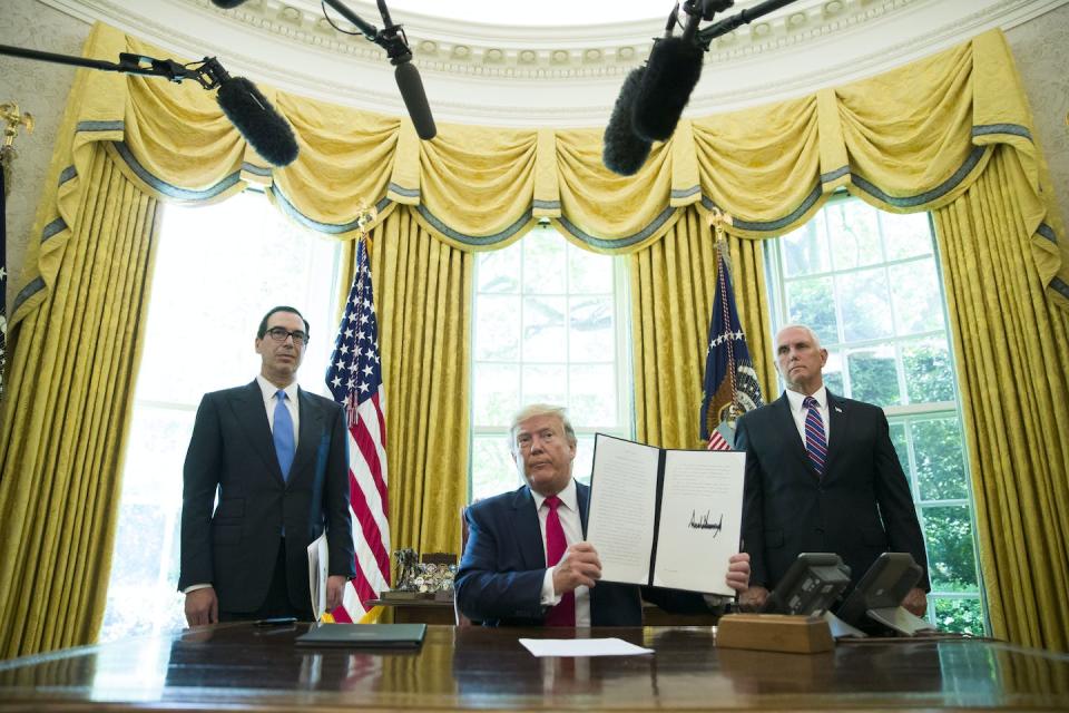 President Donald Trump holds up a signed executive order on June 24, 2019, to increase sanctions on Iran, flanked by Treasury Secretary Steven Mnuchin, left, and Vice President Mike Pence. <a href="https://newsroom.ap.org/detail/TrumpExecutiveOrders/a89440a71ec14f0384a2f0d9dda60685/photo?Query=Trump%20executive%20order%20visa%20muslim&mediaType=photo&sortBy=arrivaldatetime:desc&dateRange=Anytime&totalCount=1309&digitizationType=Digitized&currentItemNo=NaN&vs=true&vs=true" rel="nofollow noopener" target="_blank" data-ylk="slk:AP Photo/Alex Brandon, File;elm:context_link;itc:0;sec:content-canvas" class="link ">AP Photo/Alex Brandon, File</a>
