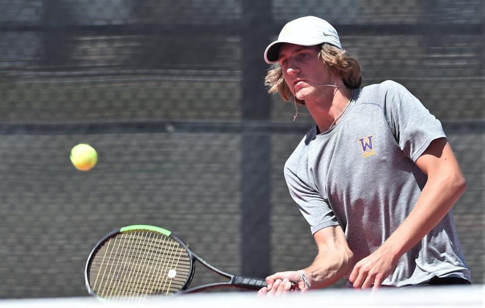 Wylie's Marshall McPherson returns a shot against Aledo's Scott Mason and Bryanna Orr in the second round of the Region I-5A mixed doubles tournament. McPherson and Bontke won the match 6-3, 6-1 on Monday at the McLeod Tennis Center in Lubbock.